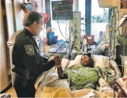  ?? BROWARD SHERIFF'S OFFICE ?? Broward County Sheriff Scott Israel visits Marjory Stoneman Douglas student Anthony Borges, who was shot multiple times.