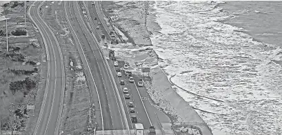  ?? ?? The ocean breached the dunes just north of the Indian River Inlet bridge March 26.