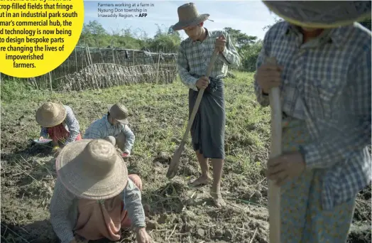  ?? — AFP ?? Farmers working at a farm in Nyaung Don township in Irrawaddy Region.