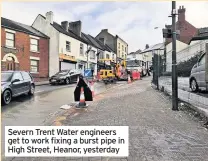  ??  ?? Severn Trent Water engineers get to work fixing a burst pipe in High Street, Heanor, yesterday