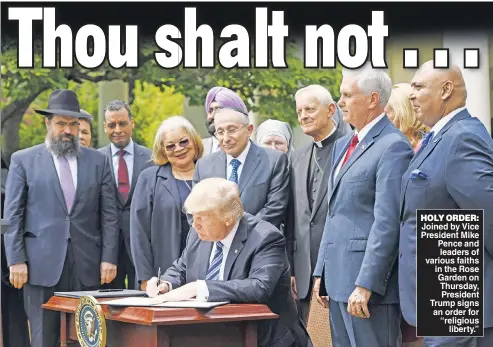  ??  ?? HOLY ORDER: Joined by Vice President Mike Pence and leaders of various faiths in the Rose Garden on Thursday, President Trump signs an order for “religious liberty.”