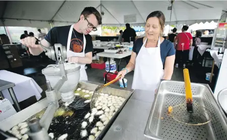  ?? DARREN STONE, TIMES COLONIST ?? Kyle Maxwell and Tina Petropoulo­s prepare loukoumade­s at last year’s Greek Fest.