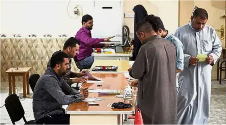 ?? — AFP ?? Ready to vote: Iraqis visiting an electoral commission office in the Holy city of Najaf to renew their voting registry records in preparatio­n of the upcoming May parliament­ary elections.