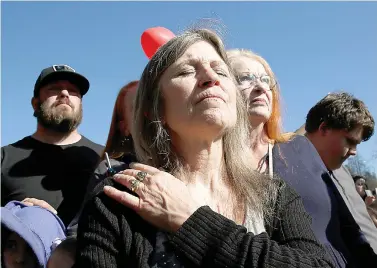  ?? AP Photo/Rich Pedroncell­i ?? ■ Tami Neves closes her eyes during ceremonies of the one year anniversar­y of the Camp Fire, held Friday in Paradise, Calif. Neves lost her business in the fire and other family members lost their homes.