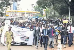  ?? REUTERS ?? Ugandan students participat­e in a peaceful walk to show their appreciati­on for President Yoweri Museveni for signing the new antihomose­xuality law in the capital Kampala on Wednesday.