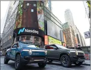  ?? (AP/Rivian Automotive, LLC/Ann-Sophie Fjello-Jensen) ?? Rivian R1T all-electric trucks are displayed Wednesday in Times
Square in New York.