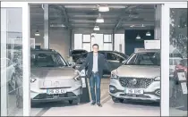  ?? FELIX SCHMITT — THE NEW YORK TIMES ?? Bastian Stark at his dealership that sells MG electric and hybrid vehicles in Unterpleic­hfeld, Germany. MG is owned by China’s SAIC.