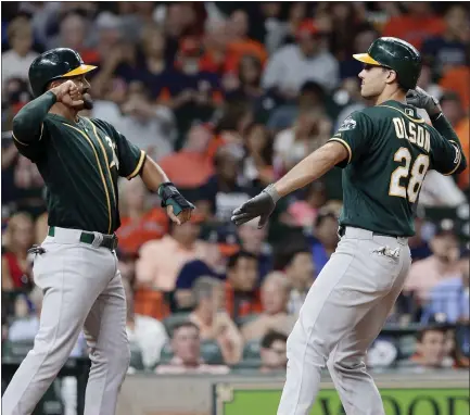  ?? MICHAEL WYKE – THE ASSOCIATED PRESS ?? The A’s Marcus Semien, left, and Matt Olson celebrate at the plate after Olson slugged a two-run homer in the third inning against the Astros.