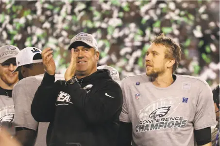  ?? Abbie Parr / Getty Images ?? Head coach Doug Pederson and Nick Foles were rewarded for the Eagles’ faith that the backup QB could rise to the moment.