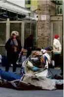  ?? DAmiAn DOVARgAnES/AP ?? Homeless people waited to enter the Midnight Mission during the late afternoon Friday in downtown Los Angeles.