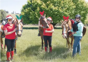  ??  ?? Getting in the festive spirit for the trail ride to enjoy the picturesqu­e local bush and wildlife are (from left) Kendall Noble, Caroline Noble and Ali Dunn.