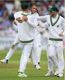  ?? Stu Forster / Getty Images ?? South Africa’s Keshav Maharaj, centre celebrates after dismissing England’s Jonny Bairstow