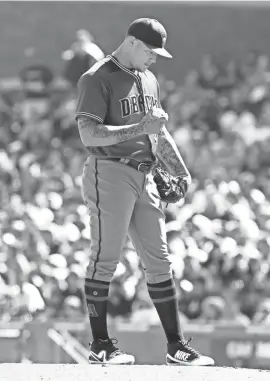  ?? GEORGE NIKITIN/AP ?? Diamondbac­ks pitcher Taijuan Walker looks down after walking home a run during the fifth inning against the Giants on Sunday in San Francisco.