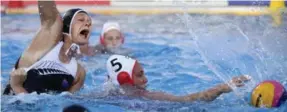  ?? SZILARD KOSZTICSAK/THE ASSOCIATED PRESS ?? Canadian Monika Eggens gets a grip on New Zealand’s Emma Stoneman before the ball in water polo action. Canada won 16-3 and will face Hungary in Monday’s quarter-finals.