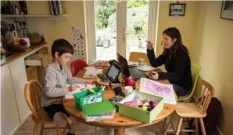  ?? GETTy iMAgES fiLE ?? HOME ROOM: A 6-year-old works on a homeschool activity while his mother works from home last week in England. Often, the responsibi­lities of homeschool­ing are falling on mothers.