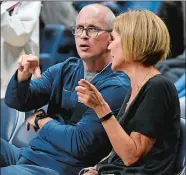  ?? JESSICA HILL/ AP PHOTO ?? UConn men’s coach Dan Hurley talks with women’s associate head coach Chris Dailey during Friday night’s First Night celebratio­n in Storrs.