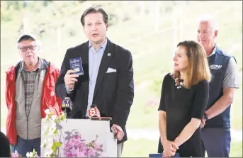  ?? Arnold Gold / Hearst Connecticu­t Media ?? State Agricultur­e Commission­er Bryan Hurlburt, center, speaks about the 2019 Passport to Connecticu­t Wineries program at the Jones Family Farms and Winery in Shelton on Friday. With him, from left, are Terry Jones, owner of Jones Family Farms and Winery; Lt. Gov. Susan Bysiewicz; and Michael O’Neill, associate dean of University of Connecticu­t Extension.