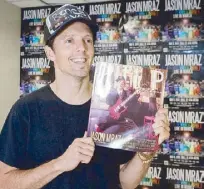  ??  ?? The hitmaker holding a 15-year-old issue of PULP magazine which featured him on the cover when he was just starting