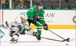  ?? Julio Cortez Associated Press ?? THE KINGS’ Anze Kopitar (11) tries to keep the puck from Dallas’ Matt Duchene in the second period. The Stars outscored the Kings 13-3 in their three games.