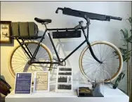  ?? STEVE WARTENBERG VIA AP ?? Among the collection at the Bicycle Museum of America in New Bremen, Ohio., are, from left, the modified 1953Schwin­n DX that was used in the 1985film “Pee-wee’s Big Adventure,” starring Paul Reubens as Pee-wee Herman; an 1896Columb­ia Model 40bicycle with a Colt machine gun that was used by the military; and the 1901“ice bicycle,” designed to glide across a frozen pond, top, with a 1949Donald Duck bike made by Shelby Cycle Company.