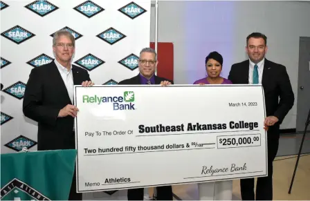  ?? (Pine Bluff Commercial/I.C. Murrell) ?? Relyance Bank CEO Chuck Morgan (left) presents a $250,000 check to Southeast Arkansas College President Steven Bloomberg, SEARK Institutio­nal Advancemen­t and Community Relations Executive Director Barbara Dunn and Chad Kline to go toward the college’s athletic campaign fund.