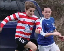  ??  ?? Enniskerry’s Oran Allman (left) battles for possession with Ashford Rovers’ Colin Ashley.