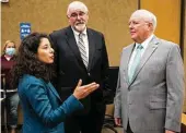  ?? Brett Coomer / Staff file photo ?? County Judge Lina Hidalgo talks to commission­ers Jack Cagle and Tom Ramsey, who want tax cuts to go even deeper than the Democratic majority proposes.