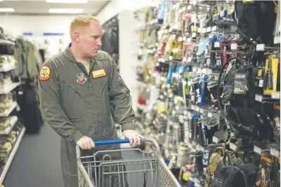  ?? Photos by Nati Harnik, The Associated Press ?? Staff Sgt. Alex Frank shops at the Military Uniform store within the Exchange at Offutt Air Force Base, Neb., in May. Starting in fall 2017, honorably discharged veterans will be eligible to shop tax-free online at the Exchange with the same discounts...