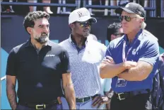  ?? AP PHOTO/SETH WENIG ?? Yasir Al-Rumayyan (left) governor of Saudi Arabia’s Public Investment Fund, Majed Al-Sorour, CEO of Golf Saudi (center) and Greg Norman, CEO of LIV Golf, watch at the first tee during the second round of the Bedminster Invitation­al LIV Golf tournament in Bedminster, N.J., on July 30, 2022.