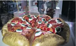  ??  ?? A textile sculpture from artist Hein Koh called Mystic Pizza is part of a group art exhibition celebratin­g all things pie at The Museum of Pizza in New York.