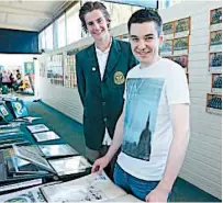  ??  ?? Marist-Sion College captain for 2016 Lachlan Pyle looks through some of the memorabili­a with 2004 college dux Daniel Slabicki.