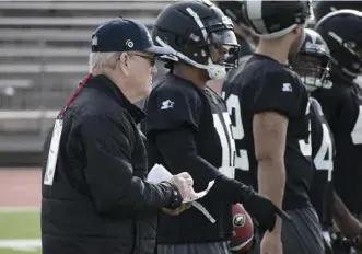  ?? Alliance of American Football via the Associated Press ?? Bill Polian, left, the Alliance of American Football’s co-founder, watches the Birmingham Iron practice recently. Polian is nearly four decades removed from a stint in the USFL.