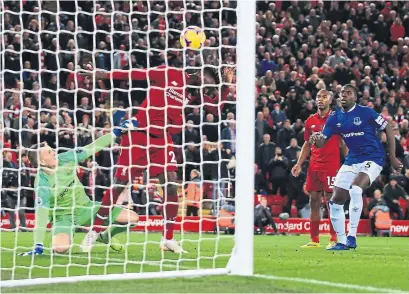  ?? SIMON STACPOOLE/OFFSIDE GETTY IMAGES ?? Divock Origi of Liverpool scores the game-winning goal in the sixth minute of injury time against Everton on Sunday at Anfield.