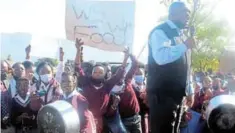  ?? Picturee: ZINTLE BOBELO ?? PAYING THE PRICE: Department of education assistant director Madoda Ndembe addresses the outraged group of pupils at Nkwanca High after the school failed to provide food for them due to the non-payment of kitchen staff and their supplier