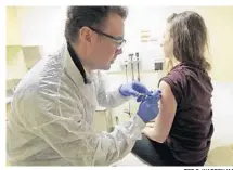  ?? TED S. WARREN/AP ?? Pharmacist Michael Witte gives Rebecca Sirull a shot. A Florida law that expands the treatments that pharmacist­s can provide may have run into a delay in implementa­tion after the state Board of Pharmacy announced its intention to add chronic conditions of heart disease and mental health.