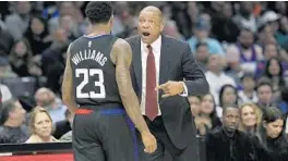  ?? GARY CORONADO/LOS ANGELES TIMES ?? Clippers head coach Doc Rivers, right, talks with guard Lou Williams (23) in March. Rivers is one of the NBA’s 10 Black head coaches.