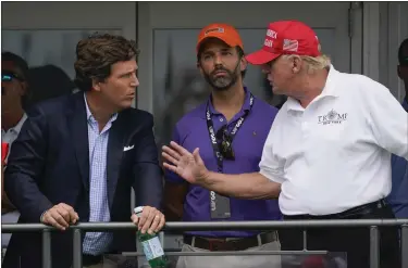  ?? SETH WENIG — THE ASSOCIATED PRESS FILE ?? Former President Donald Trump, right, talks with Donald Trump Jr., center, and Fox News’ Tucker Carlson during the final round of the Bedminster Invitation­al LIV Golf tournament in Bedminster, N.J., on July 31. Thousands of hours of surveillan­ce footage from the Jan. 6, 2021, Capitol attack are being made available to Carlson.