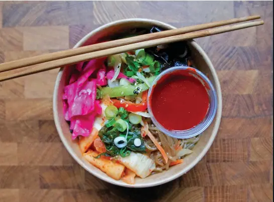  ??  ?? Bright bowl
Maht’s japchae rice bowl blends fresh ingredient­s with homemade kimchi