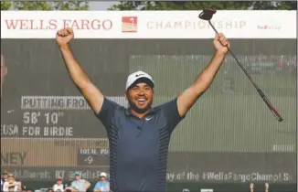  ?? The Associated Press ?? SUN-SHINY DAY: Jason Day reacts after playing partner Nick Watney’s birdie putt on 18 at the Wells Fargo Championsh­ip golf tournament Sunday at Quail Hollow Club in Charlotte, N.C. Day’s victory in Charlotte was his second of the season.