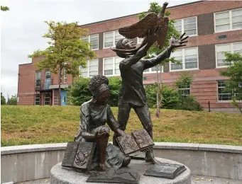  ?? Boston HerAld file ?? FLYING HIGH: A statue outside the James P. Timilty School in Roxbury depicts students releasing a bird.