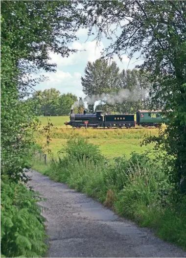  ?? ?? Cross here: Austerity 0-6-0 No. 2890 Douglas, which is to operate trains at Spa Valley‘s annual Real Ale and Cider Festival on October 7-9, approaches the railway’s Poke Hill Farm crossing in June 2021. DAVID STAINES