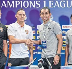  ??  ?? Muang Thong’s Teerasil Dangda, right, shakes hands with Brisbane defender Jade North.