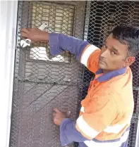  ?? ?? Dany Chand putting up shutters at his home in Viseisei Back Road, Lautoka, as a way to prepare for cyclone.
