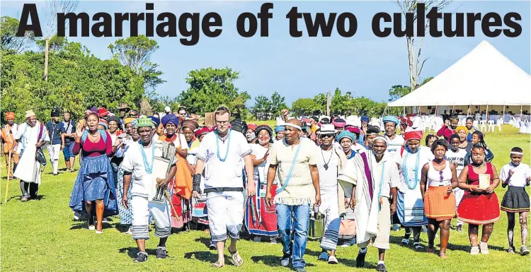 ?? Picture: BRANDON REYNOLDS ?? GOING DOWN AN AFRICAN AISLE: Groom Byron Stanton and members of the Chintsa East community make their way towards makoti Candice Weskamp for the couple’s traditiona­l Xhosa wedding at Inkwenkwez­i Private Game Reserve
