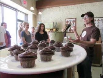  ?? BETH J. HARPAZ — THE ASSOCIATED PRESS ?? Jon Payson, owner of The Chocolate Room in Brooklyn, N.Y., explaining how he and his wife started the business in a chat with a group on A Slice of Brooklyn’s chocolate tour. The Chocolate Room is one of a number of stops on the tour. In addition to...