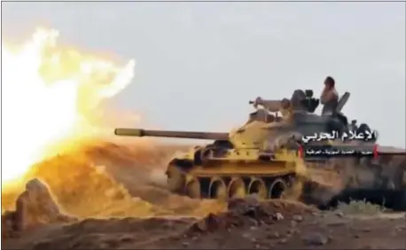  ?? SYRIAN CENTRAL MILITARY MEDIA, VIA AP ?? This frame grab from video provided Wednesday by the government-controlled Syrian Central Military Media, shows a tank firing on militants’ positions on the Iraq-Syria border. The United States and Russia are nearing an agreement on Syria for how they...