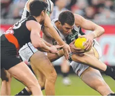  ?? Picture: AAP ?? Mason Cox, right, in action against Essendon.