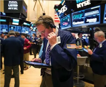  ?? Michael Nagle / Bloomberg ?? U.S. stocks fell on the New York Stock Exchange on Tuesday as markets reopened after Monday’s holiday as financial and health care shares declined.