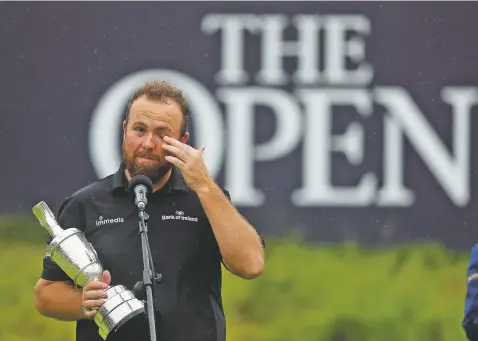  ?? JON SUPER/ASSOCIATED PRESS ?? Ireland’s Shane Lowry wipes away a tear as he makes a speech Sunday while holding the Claret Jug trophy after winning the British Open at Royal Portrush in Northern Ireland.