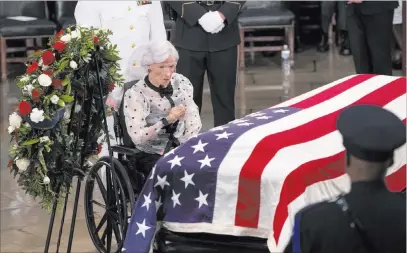  ?? J. Scott Applewhite ?? The Associated Press Roberta Mccain, the 106-year-old mother of Sen. John Mccain of Arizona, stops at his flag-draped casket Friday in the U.S. Capitol rotunda during a farewell ceremony in Washington.